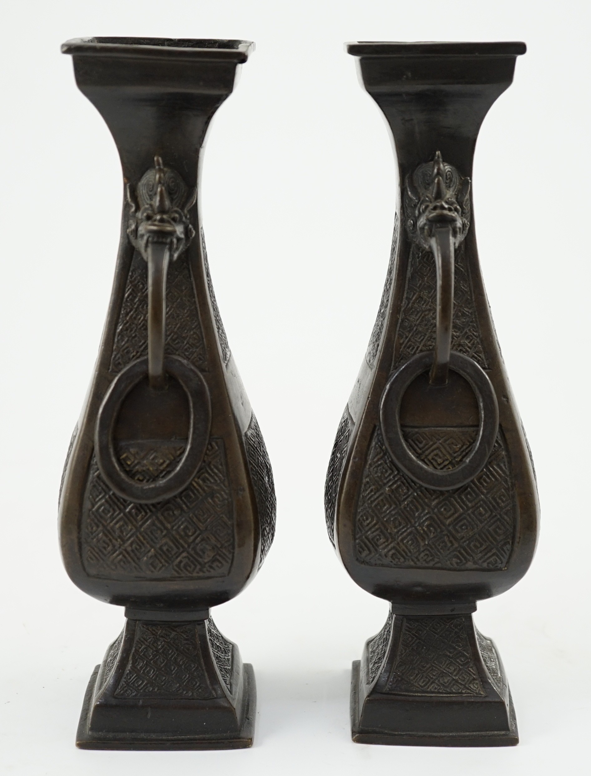 A pair of Chinese archaistic bronze two handled altar vases, Ming dynasty, 23cm high